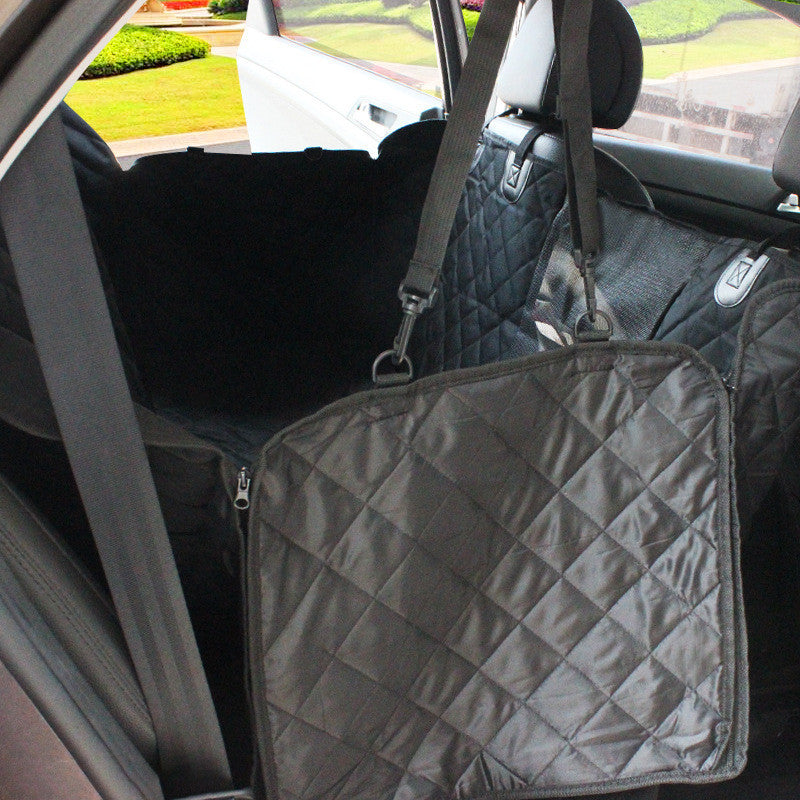 Black waterproof pet car seat cover installed in the back seat of a car