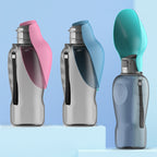 Three portable dog water bottles in pink, blue, and teal on a light blue background