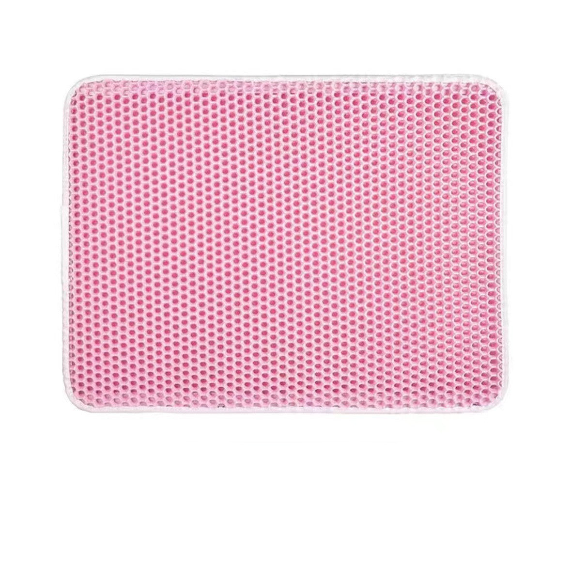 Pink honeycomb cat litter mat with white border, top view